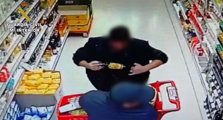 El investigado y su cómplice durante el hurto en el establecimiento burgense. /GC