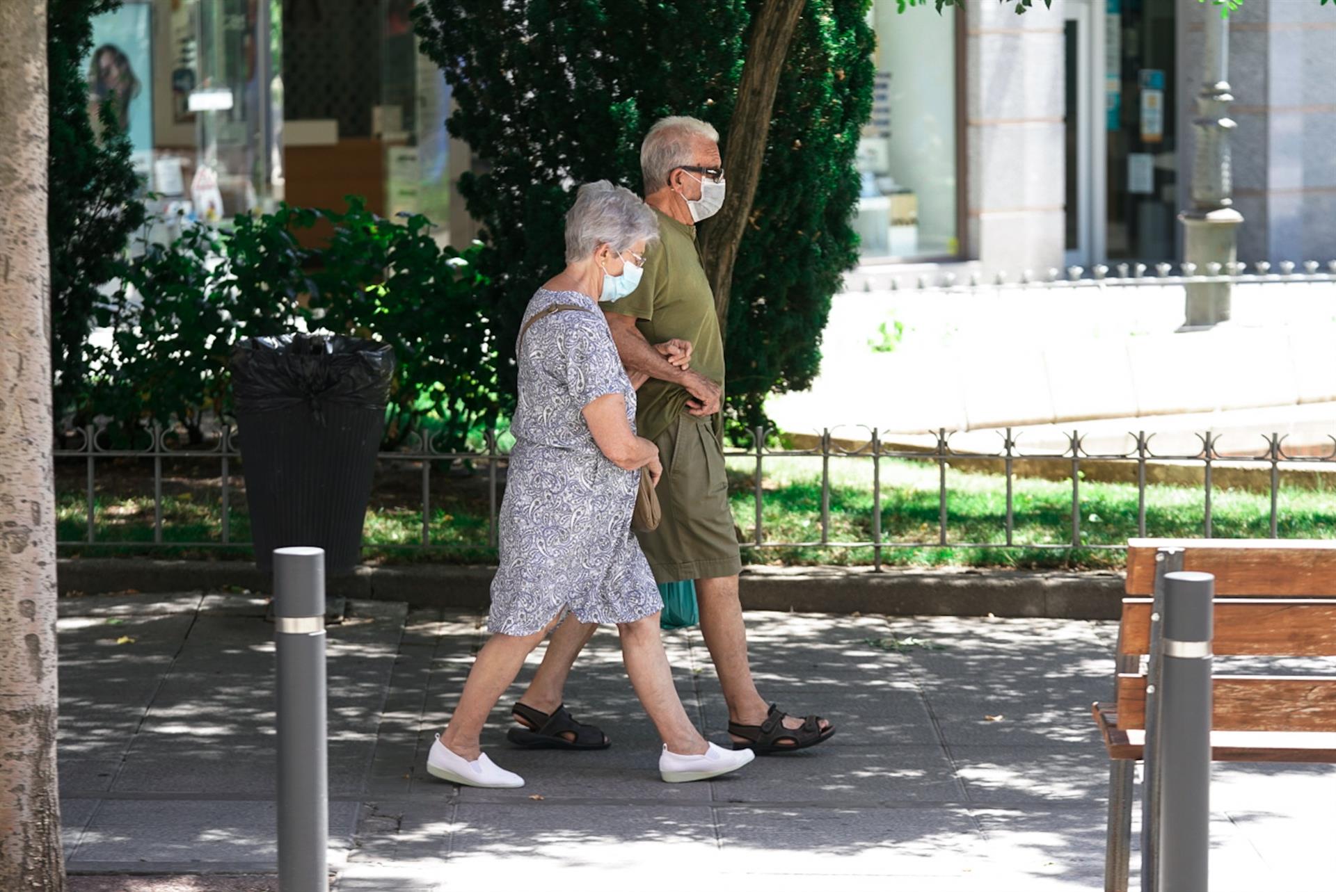 Una pareja pasea por la calle con mascarilla. Foto: EP