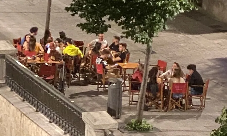 Jóvenes en una terraza de la plaza de la Reina