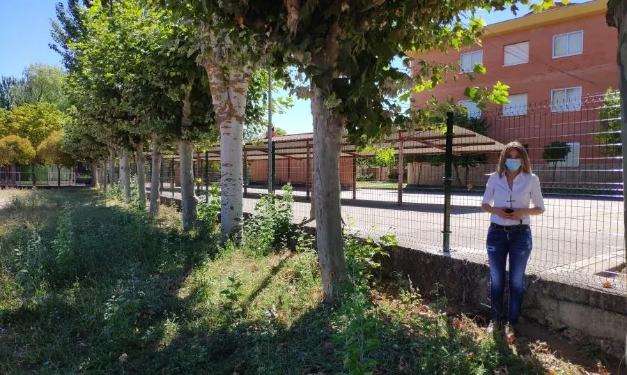La concejal Marta Labrador junto a la nueva valla del colegio Carmen Martín Gaite