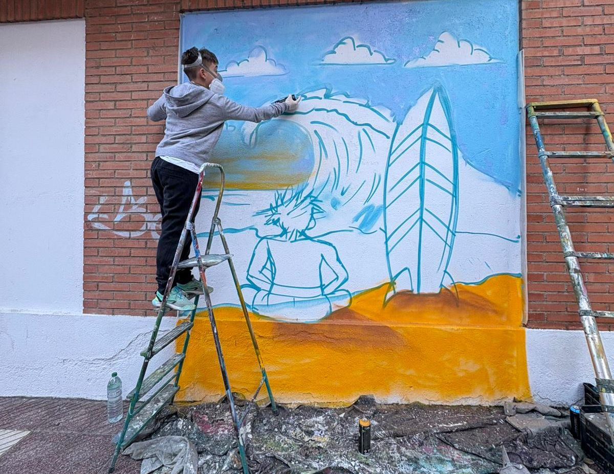 La playa de Gijón y el surf familiar inspiran el nuevo mural de un niño de Santa Marta