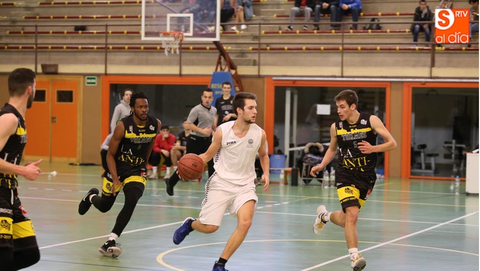 Un jugador de la Universidad conduce el balón ante un rival del Quesería La Antigua. Fotos: Alberto Martín
