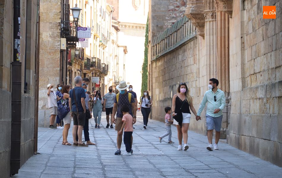 Varios grupos de personas paseando por el centro de la ciudad