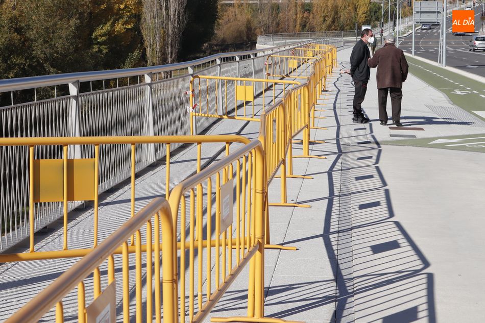 Vallas en una acera del paseo de la Transición Española, frente al Hospital, que se encuentra deteriorada y con baldosas levantadas